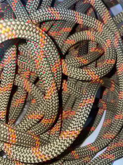 Close-up of a rope with orange and green  patterns - dog leash