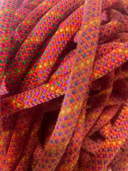 Close-up of a rope with orange/green/blue - dog leash